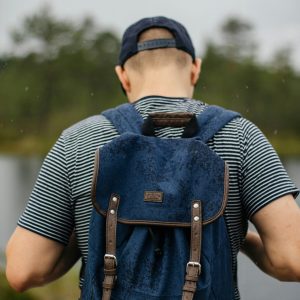 a man with a blue and borwn backpack