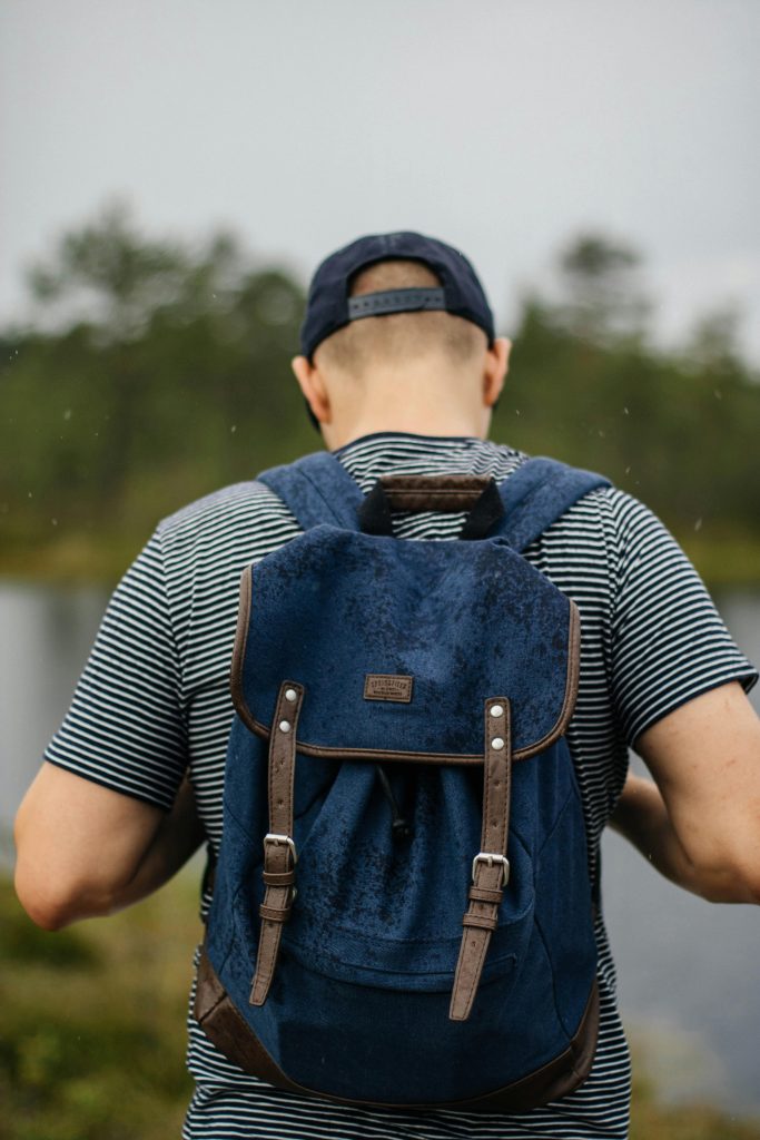 a man with a blue and borwn backpack