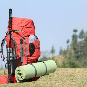 a backpack with umbrella and a mat