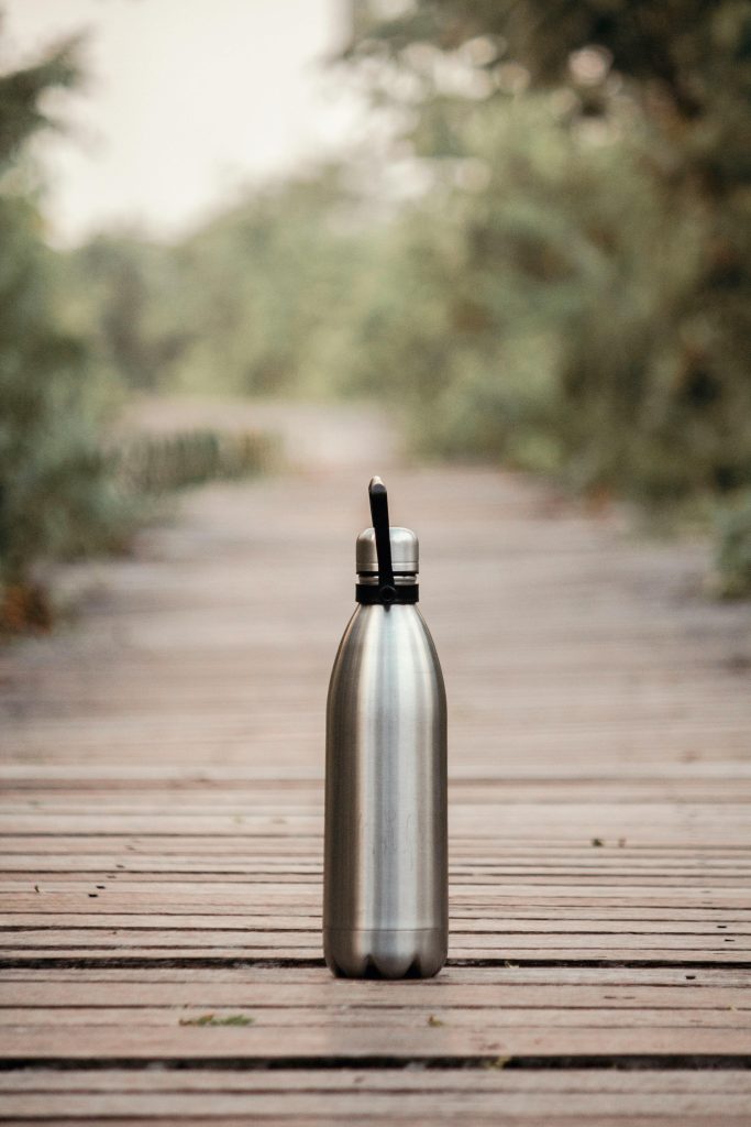 a steel waterbottle on the ground