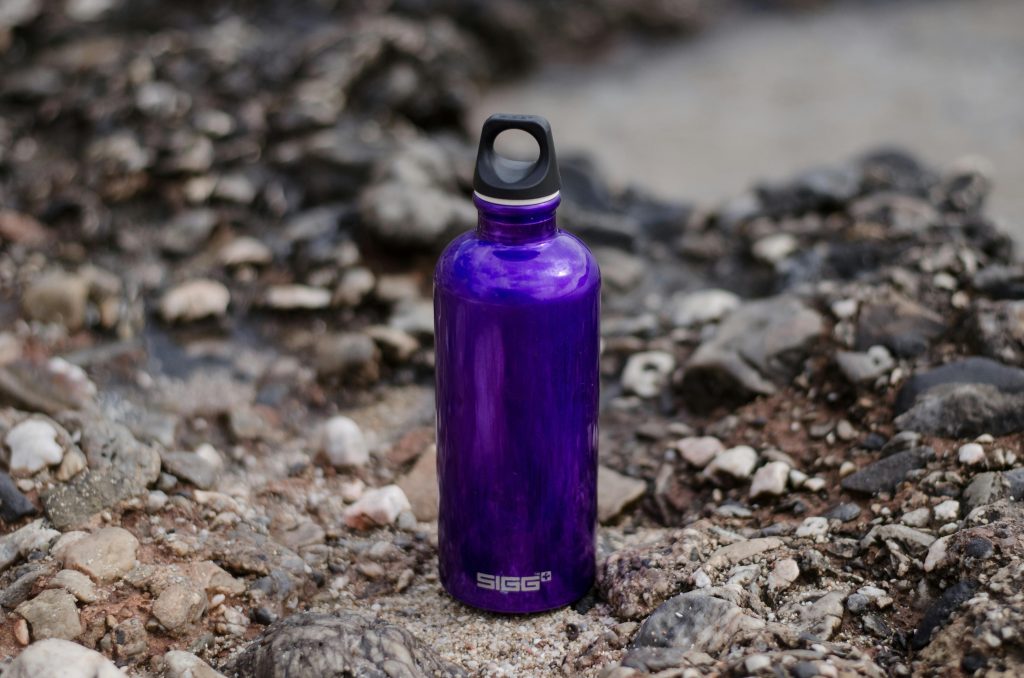 a purple waterbottle on the ground