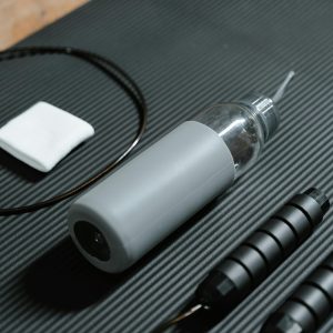 A gray waterbottle with a straw